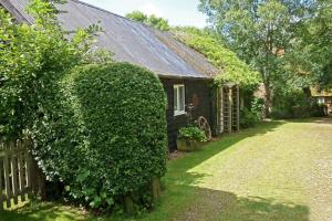 a hedge in front of a house with a fence at 2 Bed in Biddenden oc-cb559 in Biddenden