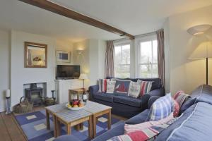 a living room with a blue couch and a table at 3 Bed in Walberswick oc-aaferr in Walberswick