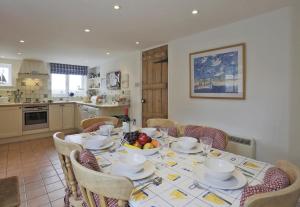 a kitchen with a table with a bowl of fruit on it at 3 Bed in Walberswick oc-aaferr in Walberswick