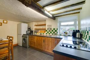 a kitchen with a sink and a refrigerator at 3 Bed in Builth Wells oc-wal257 in Maesmynis