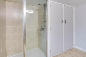a shower with a glass door in a bathroom at 3 Bed in Builth Wells oc-wal257 in Maesmynis +10 photos