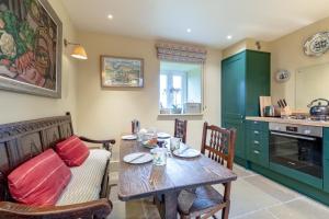a kitchen and dining room with a table and a couch at 2 Bed in Brassington oc-dcgol in Brassington