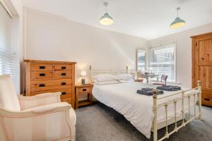 a bedroom with a bed and a desk and a chair at 3 Bed in Swanage oc-wy272 in Swanage