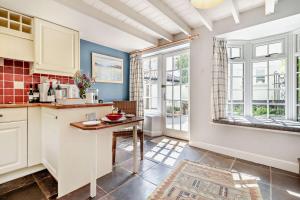a kitchen with white cabinets and a table at 1 Bed in Yoxford oc-c27254 in Wickham Market