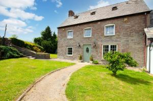 an old brick house with a green door and a gravel road at 4 Bed in Cray oc-bow288 in Cray