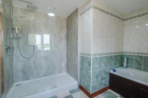 a bathroom with a shower and a tub and a sink at 4 Bed in Cray oc-bow288 in Cray +13 photos
