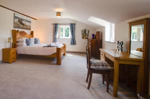 a bedroom with a bed and a desk and a table at 4 Bed in Cray oc-bow288 in Cray