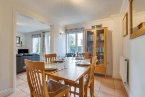 a dining room with a wooden table and chairs at 3 Bed in Southwold oc-fie2 in Reydon