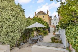 a patio with a table and an umbrella at 4 Bed in Cley oc-m33116 in Cley next the Sea