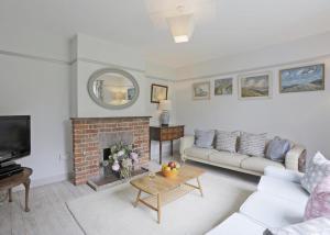 a living room with a couch and a fireplace at 4 Bed in Walberswick oc-ltm in Walberswick