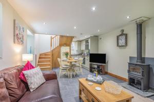 a living room with a couch and a wood stove at 1 Bed in Bodmin oc-p00438 in Bodmin