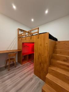 a room with a staircase and a desk and a bed at Feeling Porto House in Porto