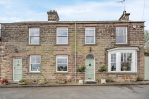 an old brick house with green doors and windows at 3 Bed in Crich oc-dcivyd in Crich
