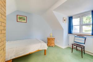 a bedroom with a bed and a chair at 4 Bed in Southwold oc-spn in Reydon