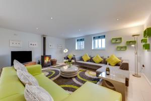 a living room with a green couch and a fireplace at 6 Bed in Knodishall oc-bil in Aldringham