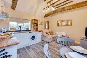 a kitchen and living room with a washer and dryer at 1 Bed in Great Waldingfield oc-ac1 in Waldingfield