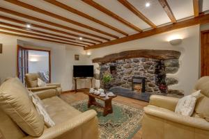 a living room with a large stone fireplace at 2 Bed in Barmouth oc-wah699 in Talybont