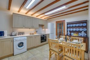 a kitchen with a table and chairs and a sink at 2 Bed in Barmouth oc-wah699 in Talybont