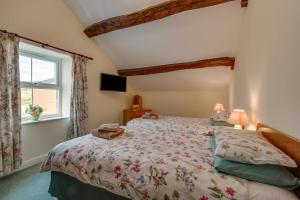 a bedroom with a bed and a window at 2 Bed in Barmouth oc-wah699 in Talybont