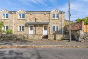 a brick house with white doors on a street at 2 Bed in Alnwick oc-e33447 in Embleton