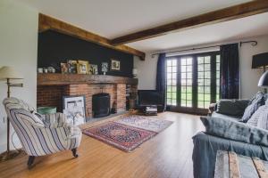 a living room with a couch and a fireplace at 3 Bed in Walberswick oc-spinn in Walberswick