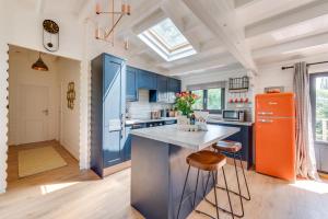 a kitchen with blue cabinets and an orange refrigerator at 2 Bed in Stradbroke oc-wopl in Stradbroke