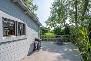 a deck with a table and chairs on the side of a house at 2 Bed in Stradbroke oc-wopl in Stradbroke