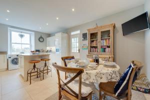 a kitchen and dining room with a table and chairs at 4 Bed in Brithdir oc-wag722 in Cross Foxes