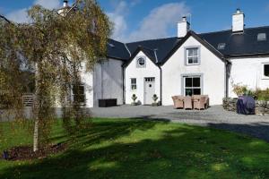 a large white house with a lawn in front of it at 4 Bed in Brithdir oc-wag722 in Cross Foxes