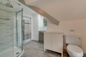 a bathroom with a toilet and a shower and a sink at 4 Bed in Brithdir oc-wag722 in Cross Foxes +17 photos