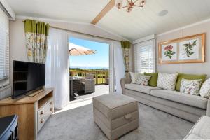 a living room with a couch and a television at 2 Bed in Abersoch oc-atacam in Abersoch