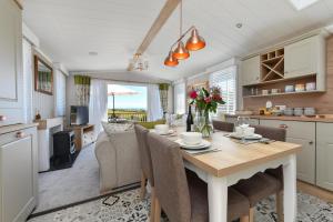 a kitchen and dining room with a table and chairs at 2 Bed in Abersoch oc-atacam in Abersoch