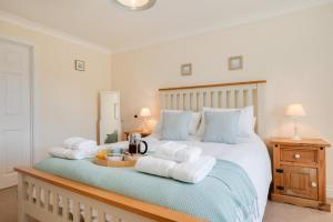 a bedroom with a bed with towels on it at 3 Bed in Trimingham oc-2290 in Trimingham