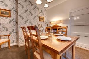 a dining room with a wooden table and chairs at 3 Bed in Hawes oc-ds1009 in Hawes +4 photos