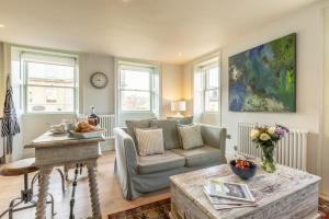 a living room with a couch and a table at 1 Bed in Bath oc-bhr48 in Bath