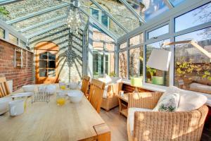 a conservatory with a table and chairs and windows at 2 Bed in Bodham oc-1303 in Bodham