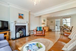a living room with a couch and a fireplace at 4 Bed in Southwold oc-l29092 in Southwold