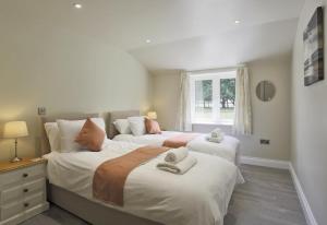 a bedroom with two beds and a window at 10 Bed in Barsham oc-rrest in Beccles