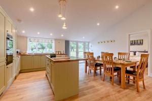 a kitchen and dining room with a table and chairs at 10 Bed in Barsham oc-rrest in Beccles