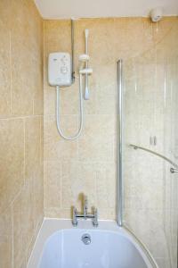 a bathroom with a shower and a bath tub at 3 Bed in Pwllheli oc-hillvi in Llanbedrog +21 photos