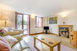 a living room with a couch and a fireplace at 2 Bed in Smallburgh oc-g33735 in Dilham