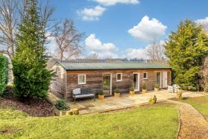 a log cabin with a bench on a patio at 1 Bed in Wadhurst oc-tw673 in Wadhurst