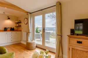 a living room with a large sliding glass door at 1 Bed in Wadhurst oc-tw673 in Wadhurst