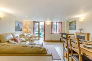 a living room with a couch and a table at 2 Bed in Smallburgh oc-g33735 in Dilham