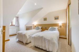 a bedroom with two beds with white sheets at 2 Bed in Smallburgh oc-g33735 in Dilham +22 photos