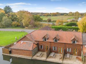 an aerial view of a wooden house on the water at 2 Bed in Smallburgh oc-g33735 in Dilham