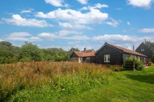 a house in a field next to a house at 1 Bed in Middleton oc-rosc in Middleton +2 photos