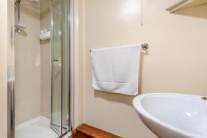 a white bathroom with a sink and a shower at 1 Bed in Reeth oc-t29540 in Reeth +22 photos