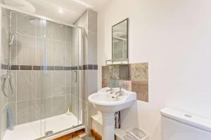 a white bathroom with a sink and a shower at 3 Bed in Outwell oc-b28260 in Upwell +16 photos