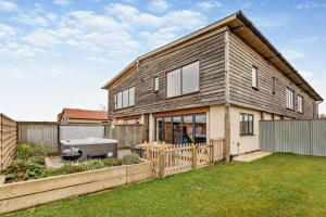 a house with a grill in a yard at 3 Bed in Outwell oc-b28260 in Upwell